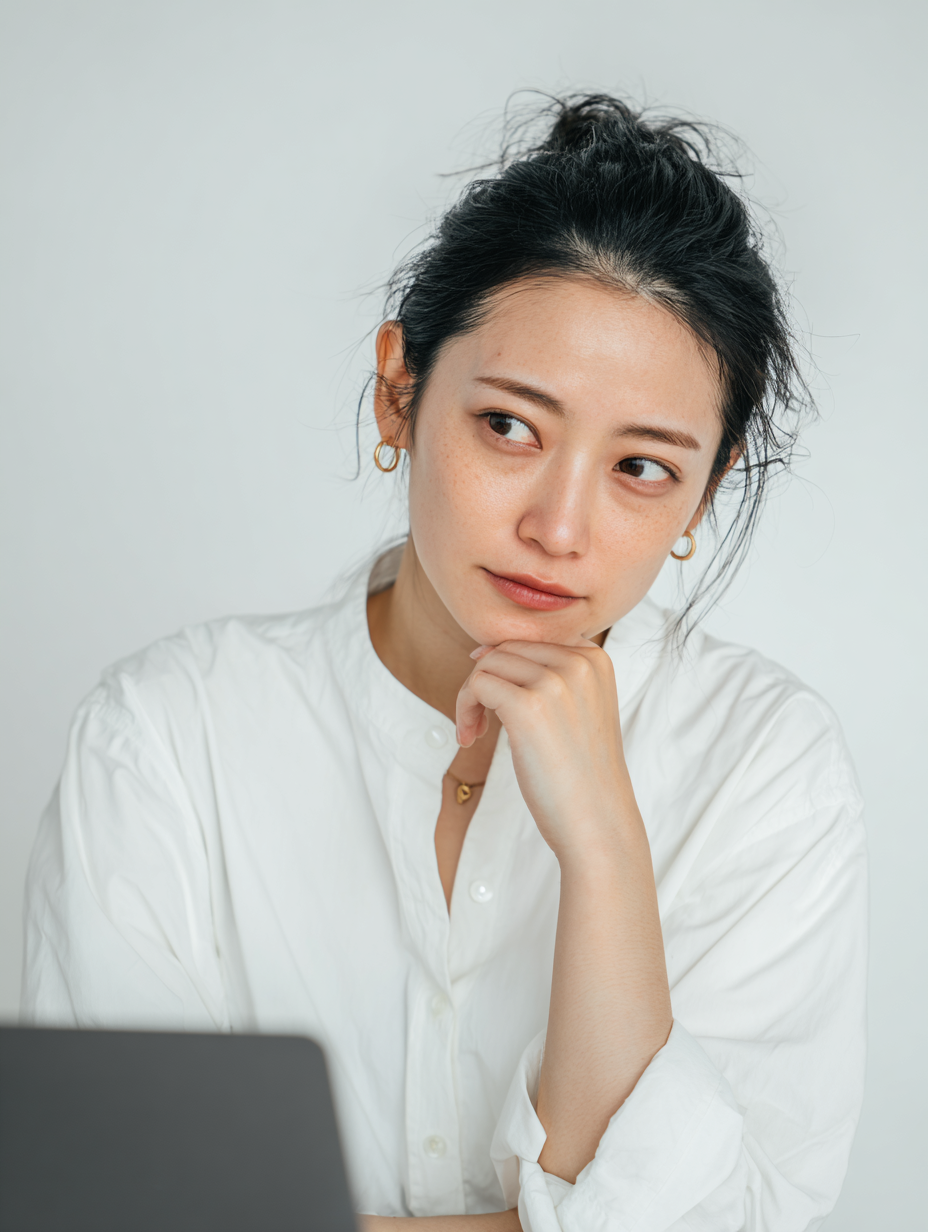 Contemplative Woman in White Shirt
